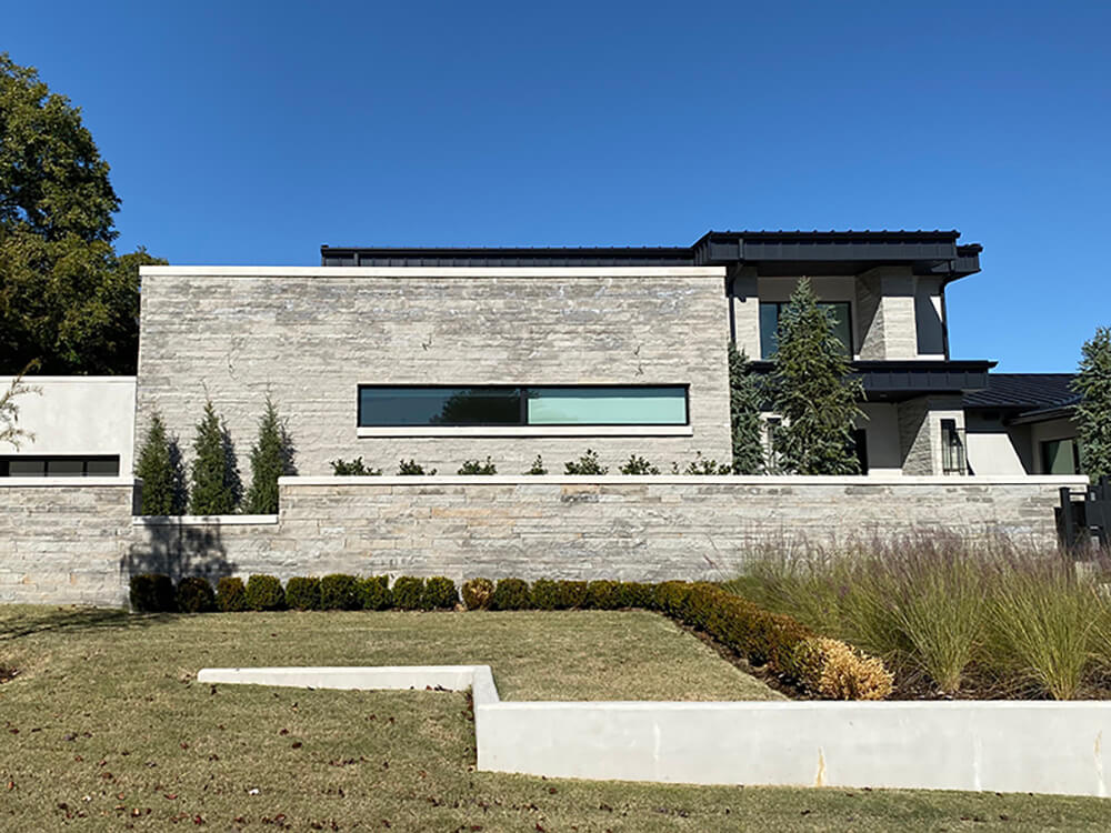 A modern home built with charcoal lueders stone.