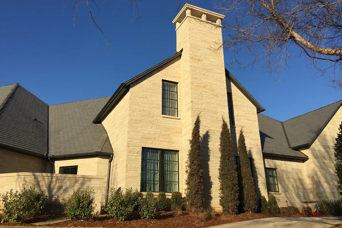 Home exterior with a natural stone fireplace
