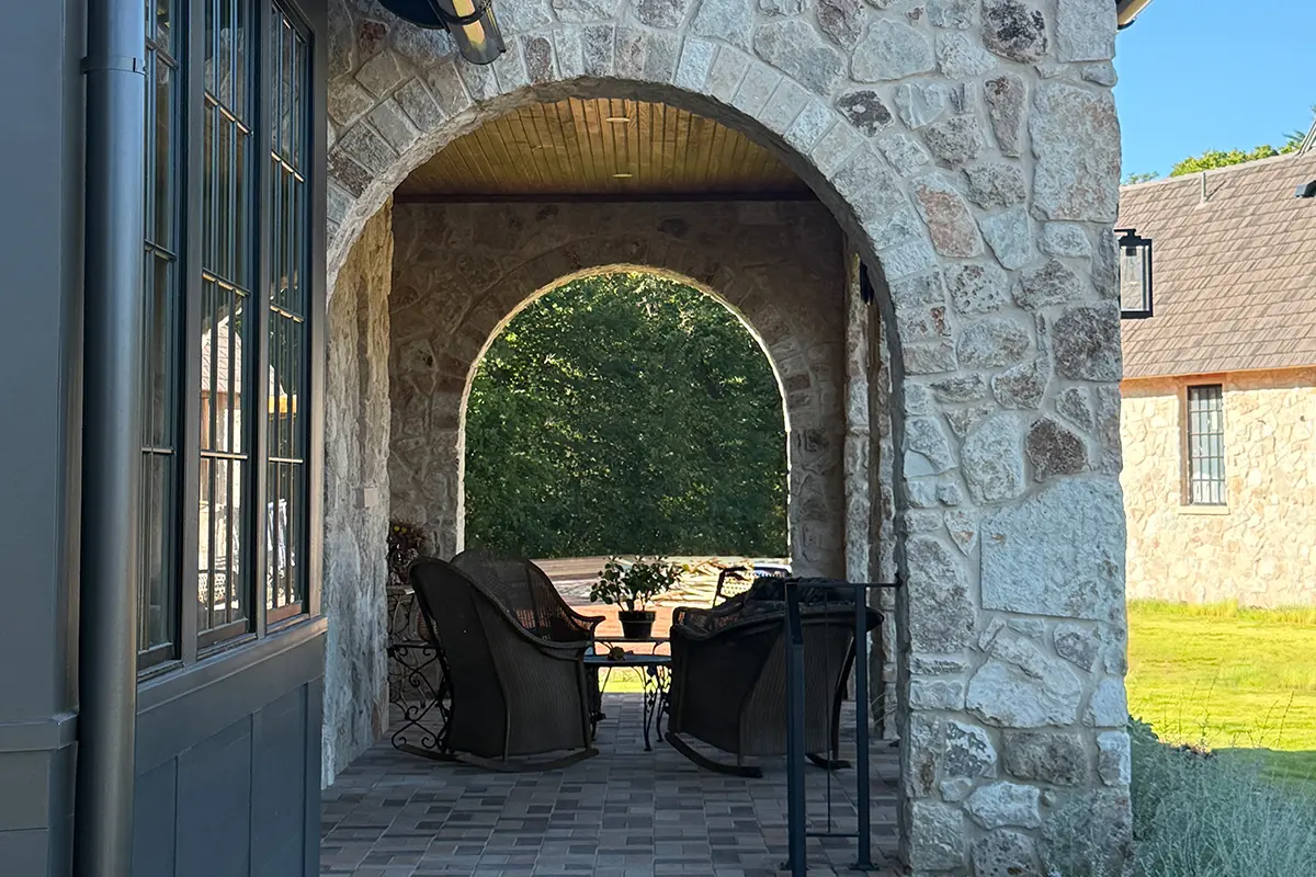 Rustic stone porch with large round stone archways